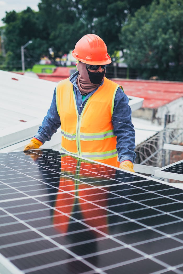 hero-gallery-04 Technician in protective gear installing solar panels on a sunny day.
