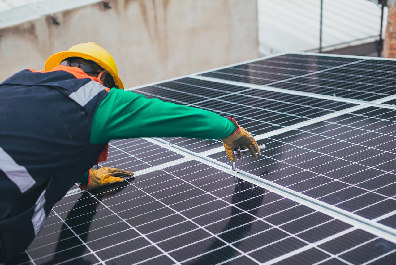 hero-gallery-03 Technician installing solar panels on a rooftop for sustainable energy solutions.